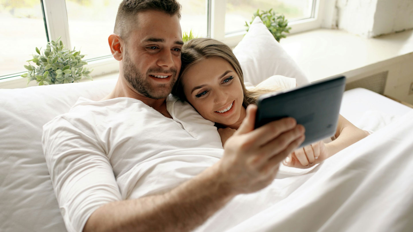 Soft, intimate couple watching something together