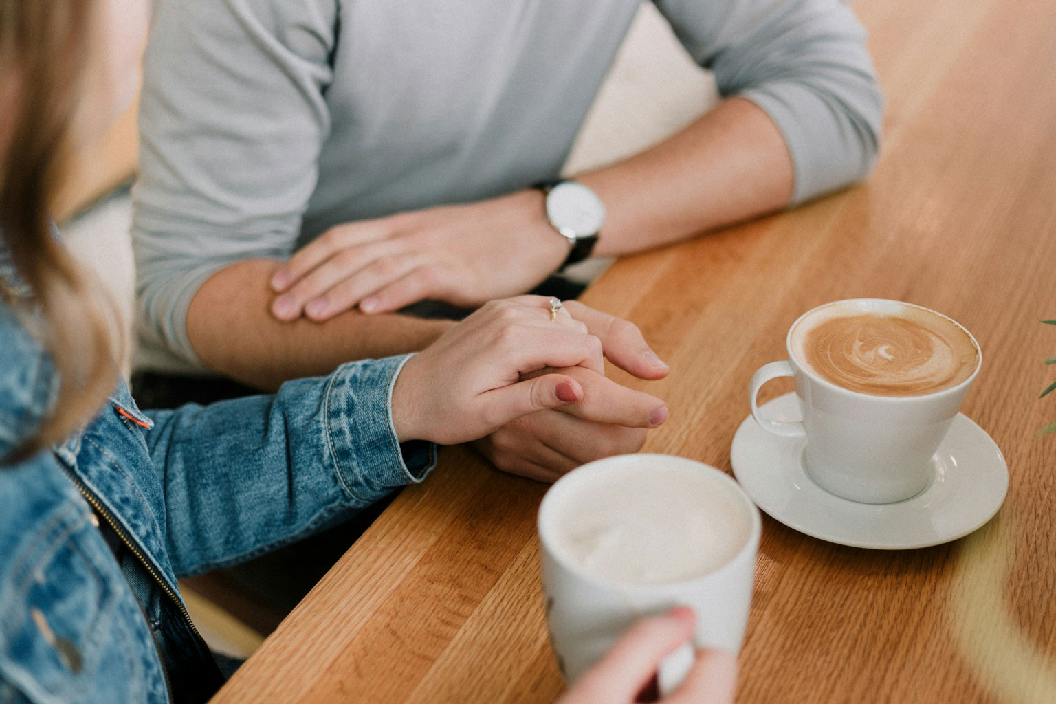 Couple having a relaxed conversation over coffee at home